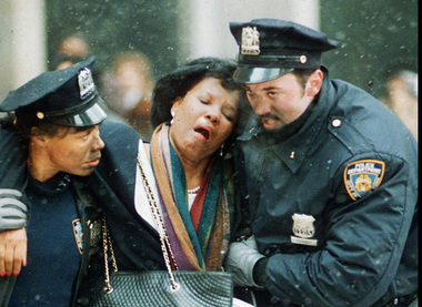Two New York City police officers help an injured women away from the scene of the World Trade Center explosion in this February 26, 1993 file photo.Joe Tabacca/Associated Press