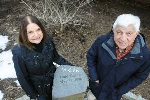 Andrea and Herb Ouida at the marker for their son, Todd, at the Memorial Garden at the River Edge Public Library. Photo – Mitsu Yasukawa; The Record