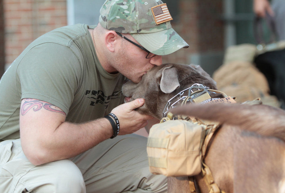 Andrew Einstein, a Westampton police officer and former Marine, kisses his service dog Gunner, before they walk from the Liberty Bell in Philadelphia to One World Trade Center in New York City. Joe Warner  for NJ.com 
