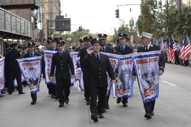 FDNY members wearing banners honoring the FDNY firefighters killed at the World Trade Center Photo NY Daily News