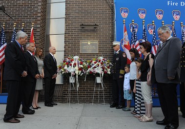 The plaque is blessed outside of Engine 10/Ladder 10.