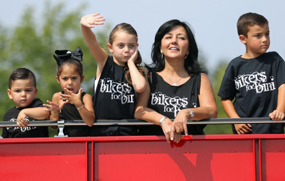 Christine Bini, wife of FF Carl Bini, is on the Bini fire truck with a few of her grandkids as they wave at the bikers heading out from the Staten Island Mall parking lot. August 30, 2015 Photo - Hilton Flore Staten Island Advance 