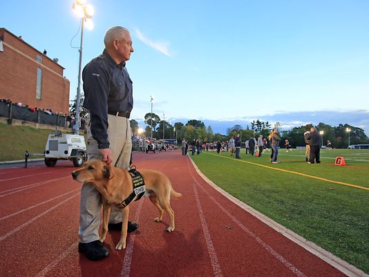 TSA agent David Wills and his explosive-sniffing dog Riverso attend the annual Joe Riverso memorial at Stepinac High School. Photo Carucha L. Meuse, The Journal News