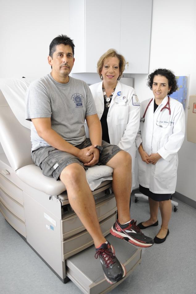 NYPD Detective Amadeo Pulley, left, was among the first World Trade Center responders to get cancer as a result to exposure to toxins at Ground Zero in 2001. Practice Nurse Navigator Tina Engel and Dr. Leigh Wilson are pictured with him at the North Shore Hospital /LIJ WTC Health Center in Queens, N.Y. Julia Xanthos/New York Daily News
