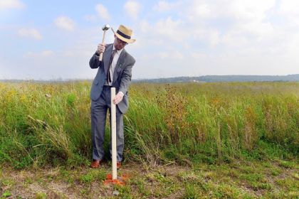 Gordon Felt, the president of Families of Flight 93, nails a stake into the ground marking the exterior wall of the new visitors center in Stonycreek, Somerset County, in September. Michael Henninger, Post-Gazette