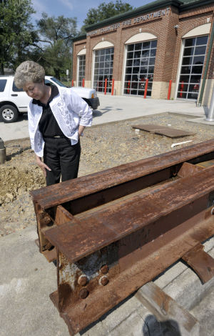 Emma Johnson of the Marion VFW Ladies Auxiliary looks over a 4,000 lb. steel beam from the World Trade Center that will soon be on permanent display outside of the fire station. Photo Andre Teague