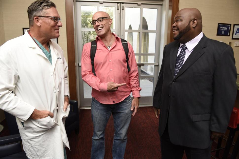 From left, Dr. Dean Lorich, director of orthopedic trauma service at New York-Presbyterian, talks to former patients Matt Long, a retired firefighter and Tarrell Lee, a NYPD traffic enforcement officer. Barry Williams for New York Daily News