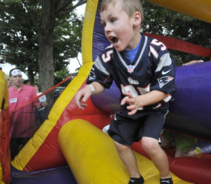 Jacob Logan 4 of Mansfield jumps through a blow up obstacle course. The annual McGinty Family Fun Day was held on the Foxboro Common on Saturday. All proceeds go to the McGinty Scholarship Foundation.