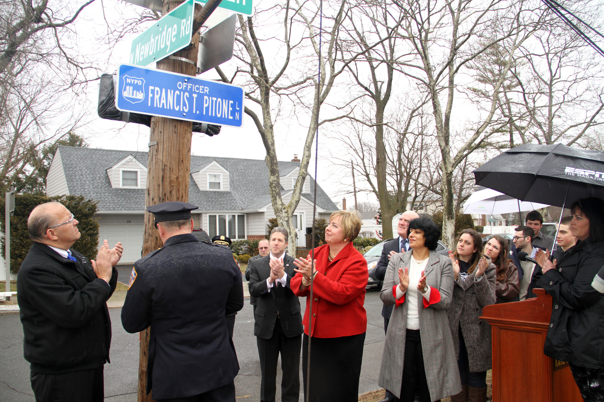 The unveiling of a street sign dedicated to Officer Francis T. Pitone, an NYPD officer and September 11 first responder who died last August, was met with applause.