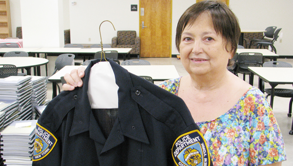 Terri Prough displays the 9/11 uniform donated to East St. John High School.