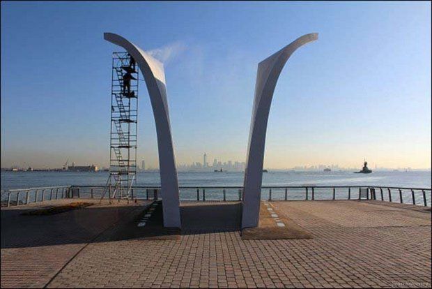 A worker cleans the face of the Postcards Memorial in St. George. (Sean Sweeney)