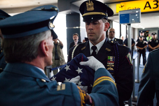 The United States Honor Flag arrived at Newark International Airport to honor Jersey City Police Officer Melvin Santiago July 16, 2014. T Chase Gaewski, The Jersey Journal