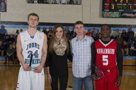 Family members of Matt O'Mahony and Glenn Wall present awards to the 2014 memorial game MVPs. Pictured (Left to Right): Jimmy Hammer, A&S '14; Avery Wall; Robert O'Mahoney, Jr.; and Malique Killing from Muhlenberg College.