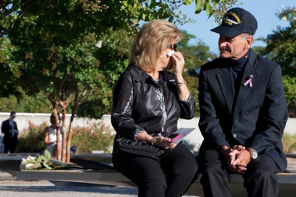 Betsy Wolk, with her husband, Herb Wolk, of Columbia, Md., wipes her eyes as they visit the bench dedicated to their late son-in-law, Navy Lt. Darin Pontell, on Friday, September 11, 2015, at the Pentagon Memorial on the 14th anniversary of the terrorist attacks on New York and Washington. Jacquelyn Martin AP