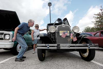 Hugh Redston, who is visiting from England, left, gets a closer look at the engine of a 1931 Model A Ford  Photo by Daniel Freel/New Jersey Herald