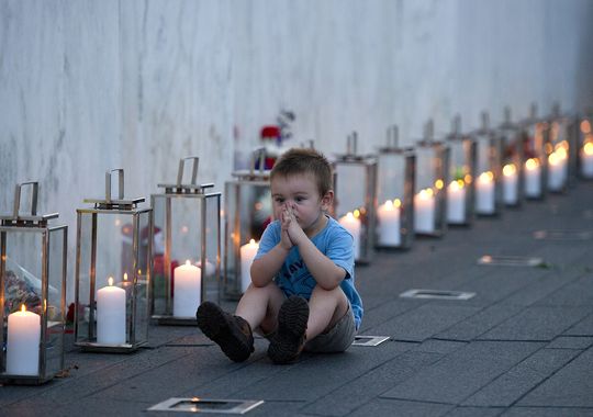Blake Catanese sits near 40 candles at the Flight 93 Memorial Wall of Names in Shanksville.  (Photo: Jack Gruber, USA Today)