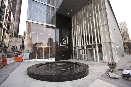 A circular water feature sits outside the lobby entrance at the corner of Greenwich and Cortland Streets.