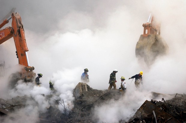 Firefighters wade through a cloud of dust and debris at Ground Zero. Stan Honda / AP Images