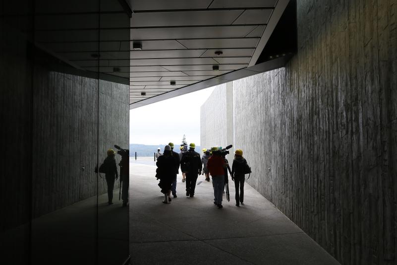 Journalists walk through a walkway at the visitors center building at the Flight 93 National Memorial, in Shanksville, Pa. during a press tour of the ongoing construction. (AP Photo/Keith Srakocic)