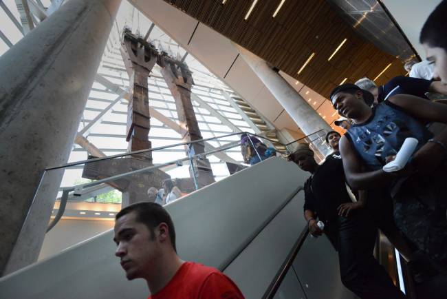 Alex (left) and others in the group ride the escalator to the lower level of the museum. They pass two huge steel beams from the World Trade Center. Carmine Galasso, The Record