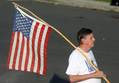 John Leide of Great Kills with the flag that he always runs with during the 2012 Memorial Day Run. Staten Island Advance/Hilton Flores