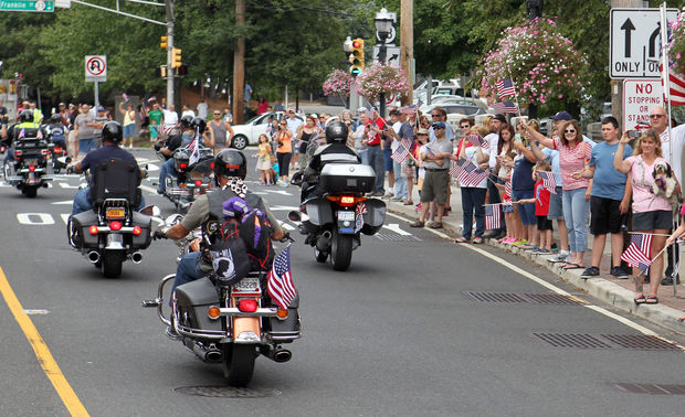 The crowd cheers as hundreds of motorcyclists take part in America's 9/11 Ride as they pass through Hightstown, NJ, August 16, 2014. Beverly Schaefer