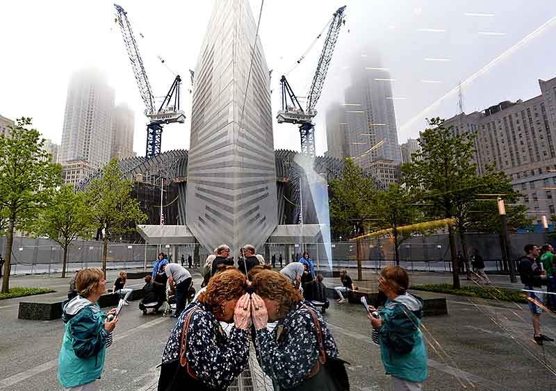 A woman tries to look through the windows of the National September 11 Memorial Museum. (Justin Lane/Getty Images)