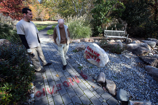 West Windsor Township workers Paul Grasselli and Jack King examine the vandalism at the Ronald Roger Arboretum at Clarksville and Princeton-Hightstown roads in The Township on Monday, November 3, 2014. Martin Griff, Times of Trenton