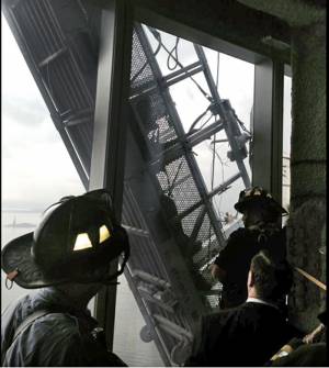 This photo, from the Fire Dept. of New York Twitter page, shows a window washer's gondola as it hangs from 1 World Trade Center, in New York, Wednesday, Nov. 12, 2014. AP Photo/Fire Dept. of New York, Twitter